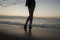 Legs of a young girl on sea and sandy beach Royalty Free Stock Photo