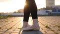 Legs of young woman ballerina standing in the classic stand on the full feet - sunset