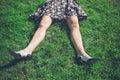 Legs of young woman lying on grass in field Royalty Free Stock Photo