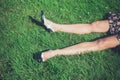 Legs of young woman lying on grass in field Royalty Free Stock Photo