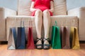 Legs of young woman sitting on sofa. Shopping concept Royalty Free Stock Photo