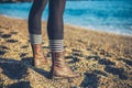 Legs of young woman standing on beach