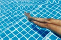 A legs of a young woman in a swimming pool Royalty Free Stock Photo