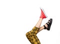 Legs of a young woman in trendy red sneakers and sandals on white background Royalty Free Stock Photo