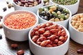 Legumes assortment in bowls on a wooden table