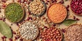 Legumes assortment, a flat lay panorama on a brown background