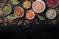 Legumes assortment, shot from above on a black background with copy space. Lentils, soybeans, chickpeas, red kidney Royalty Free Stock Photo
