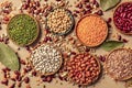 Legumes assortment, shot from above on a brown background. Lentils, soybeans, chickpeas, red kidney beans Royalty Free Stock Photo