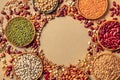 Legumes assortment, shot from the top on a rustic brown background with a place for text. Lentils, soybeans, chickpeas Royalty Free Stock Photo