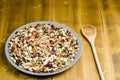 Legumes in a dish on wood, with spoon, close up