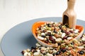 Legumes in a dish on wood, with spoon, close up, Royalty Free Stock Photo