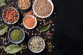 Legumes flatlay assortment, shot from above on a black background with copy space. Lentils, soybeans, chickpeas, red Royalty Free Stock Photo