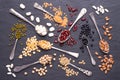 Legumes, lentils, chikpea, dry peas and beans in spoons on stone background. Top view Royalty Free Stock Photo