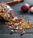 Legumes mix spilled on blue tabletop, closeup view Royalty Free Stock Photo
