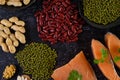 Legumes and salmon placed on a black cement floor