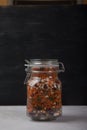 Legumes White and red beans, green and red lentils in a closed glass jar on a white table on a black background. Healthy eating Royalty Free Stock Photo