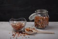 Legumes White and red beans, lentils, peas in a glass jar and in a glass cup, sprinkled beans and a wooden spoon on a white table Royalty Free Stock Photo