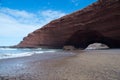 Legzira rock formation during day time with people walking under it Royalty Free Stock Photo