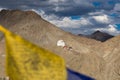 Leh Palace in Leh city, Ladakh, India. the palace is on the mountain viewing from Santi Stupa with blurred Buddha flag on foregrou