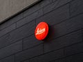 Leica Camera Logo on a Dark Wall