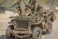 Men dressed in wartime US army soldiers uniform reenacting military maneuvers during Victory Day Europe Celebration Event