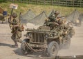 Men dressed in wartime US army soldiers uniform reenacting military maneuvers during Victory Day Europe Celebration Event