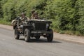 Men dressed in wartime US army soldiers uniform riding in military jeeps during Victory Day Europe Celebration Event at Great Ce