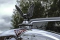 Polished hood ornament of the Alvis car company on the bonnet of