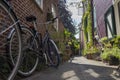 Historical alley, Arend Roelandsteeg, in the center of Leiden with bikes and plants in summer