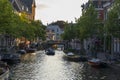 Houses, boats and bicycles at the Oude Rijn canal at sundown