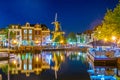 LEIDEN, NETHERLANDS, AUGUST 8, 2018: Night view of Beestenmarket and de Valk windmill in Leiden, Netherlands