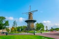 LEIDEN, NETHERLANDS, AUGUST 8, 2018: People are passing by the windmill de Valk in Leiden, Netherlands