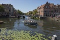 Leiden, Netherlands - August 3, 2018: Pleasure vessels at a Leiden historic canal, Oude Rijn, in summer