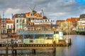 Leiden, Netherlands harbour at canal and windmill Royalty Free Stock Photo