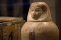 closeup of a canopic jar with the head of a human from ancient Egypt.