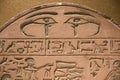 Exhibition Gods of Egypt. Ancient Egypt hieroglyphics on a stela with two eye symbols on t