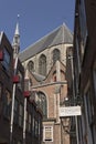 Leiden, Netherlands - July 17, 2018: Tower and roof of the Gothic monument Hooglandse church seen from a small alley in Leiden