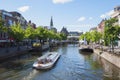 Leiden.Canal boat on the Nieuwe Rijn,with the Kaasmarkt, Koornbrug and City hall Royalty Free Stock Photo