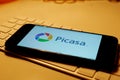 Leipzig, Germany - February 10, 2021: Closeup of smartphone screen with logo lettering of Picasa on computer keyboard