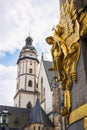 Leipzig, Germany - June 25, 2022: The the bell tower of the Thomaskirche. The golden sculpture of the Commerzbank or former Royalty Free Stock Photo