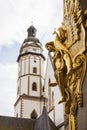Leipzig, Germany - June 25, 2022: The golden sculpture of the Commerzbank or former Konfektionshaus Ebert sharp in foreground and Royalty Free Stock Photo