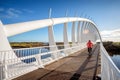 Leisure activity exercise image of a man biking across a bridge