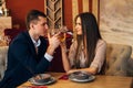 Smiling couple having dinner and drinking white wine at date in restaurant Royalty Free Stock Photo