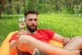 Leisure concept, camping, summer vacation. Young man of with glasses of wine laying at sofa. Relaxing and enjoying life Royalty Free Stock Photo