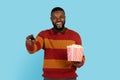 Leisure Concept. Cheerfuk Black Young Man Holding Popcorn And Remote Controller Royalty Free Stock Photo