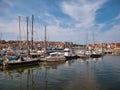 Leisure craft and small fishing boats moored at floating pontoons in Whitby Marina, UK at the mouth of the River Esk