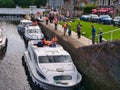 Leisure cruiser boats pass through the staircase locks at Fort Augustus in the Great Glen, Scotland, UK