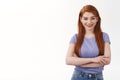 Leisure, education and business concept. Attractive cheerful, outgoing redhead girl with long ginger hair, cross arms