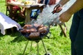 Man cooking meat on barbecue grill at summer party Royalty Free Stock Photo