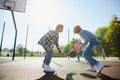 Group of friends bonding outdoors to play street basketball. Teens wearing casual style clothes. Kids look happy Royalty Free Stock Photo